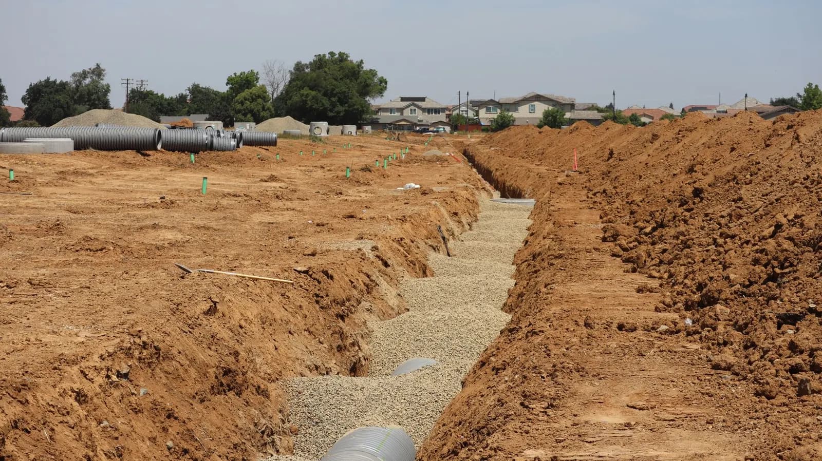 Open trench with new drainage pipework on site